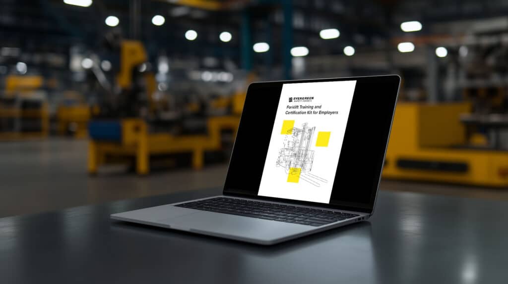 Laptop in a warehouse showing the cover page to our Forklift Instructor Kit PDF